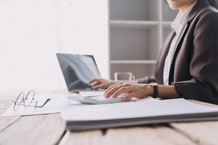 Close up bookkeepers working with balance sheet to analyze problems and find solutions to bringing develop business organization and company's stock market system. Common stock and preferred stock.の写真素材