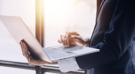 Financial analysts analyze business financial reports on a digital tablet planning investment project during a discussion at a meeting of corporate showing the results of their successful teamwork.の写真素材