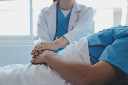 Women Asian doctors hold the patient hand and encourage and provide medical advice While checking the patient health in bed. Concept of Care and compassion, antenatal care, Threatened abortionの写真素材