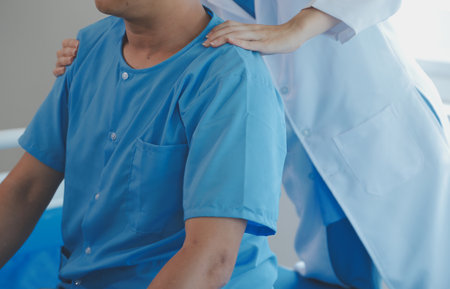 Physiotherapist working with patient in clinic, closeupの写真素材