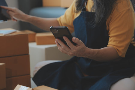 Entrepreneurs Small Business SME Independent men work at home Use smartphones and laptops for...