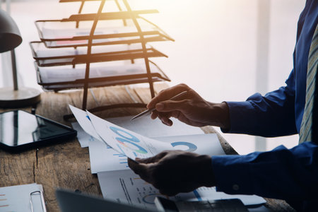 Businesswoman or accountant working Financial investment on calculator, calculate, analyze business and marketing growth on financial document data graph, Accounting, Economic, commercial concept.の写真素材