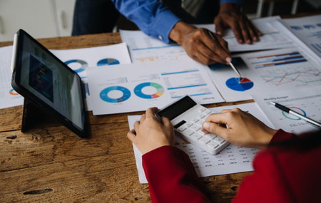 Businesswoman or accountant working Financial investment on calculator, calculate, analyze business and marketing growth on financial document data graph, Accounting, Economic, commercial concept.の写真素材