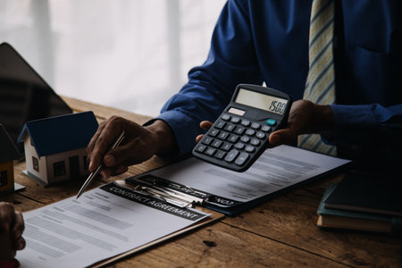 Businesswoman or accountant working Financial investment on calculator, calculate, analyze business and marketing growth on financial document data graph, Accounting, Economic, commercial concept.の写真素材