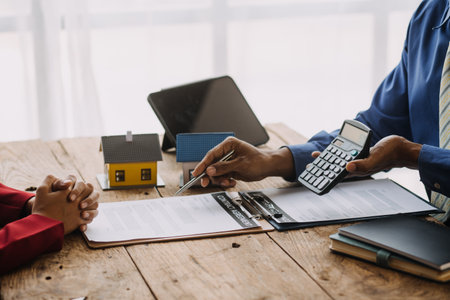 Businesswoman or accountant working Financial investment on calculator, calculate, analyze business and marketing growth on financial document data graph, Accounting, Economic, commercial concept.の写真素材