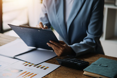 Business Documents, Auditor businesswoman checking searching document legal prepare paperwork or report for analysis TAX time,accountant Documents data contract partner deal in workplace officeの写真素材