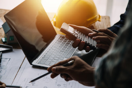 Construction and structure concept of Engineer or architect meeting for project working with partner and engineering tools on model building and blueprint in working site, contract for both companies.の写真素材