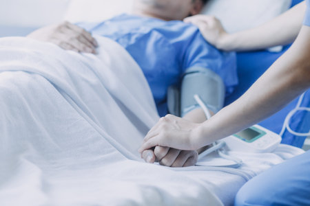 Side view of diverse doctors examining Asian female patient in bed in ward at hospital.の写真素材