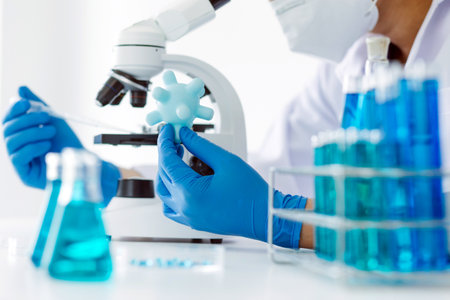 biochemical research scientist team working with microscope for coronavirus vaccine development in...