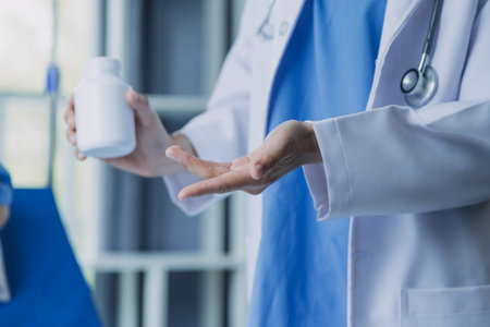 Side view of diverse doctors examining Asian female patient in bed in ward at hospital.の写真素材