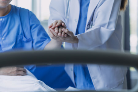 Side view of diverse doctors examining Asian female patient in bed in ward at hospital.の写真素材