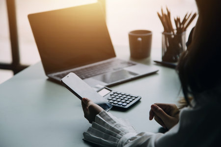 Group of confident business people point to graphs and charts to analyze market data, balance sheet, account, net profit to plan new sales strategies to increase production capacity.の写真素材
