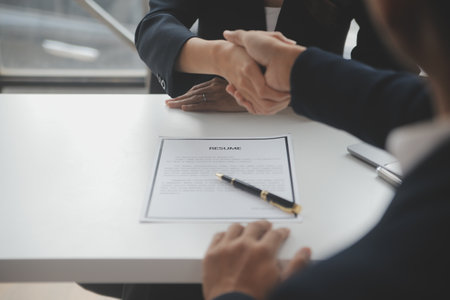 Close up view of job interview in office, focus on resume writing tips, employer reviewing good cv of prepared skilled applicant, recruiter considering application, hr manager making hiring decisionの写真素材