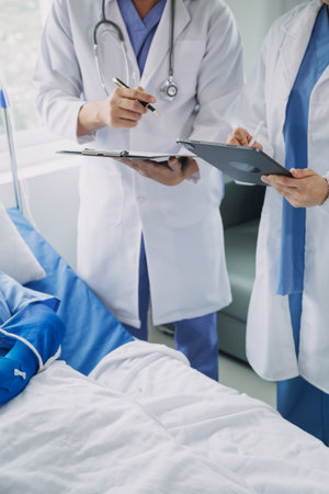 Injured patient showing doctor broken wrist and arm with bandage in hospital office or emergency room. Sprain, stress fracture or repetitive strain injury in hand. Nurse helping customer. First aid.の写真素材