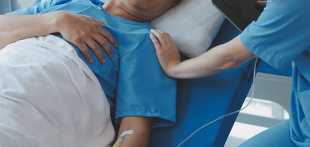 Women Asian doctors hold the patient hand and encourage and provide medical advice While checking the patient health in bed. Concept of Care and compassion, antenatal care, Threatened abortionの写真素材