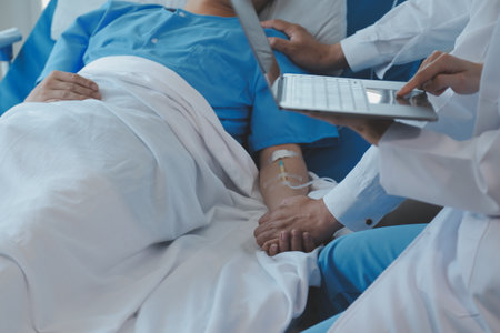 Women Asian doctors hold the patient hand and encourage and provide medical advice While checking the patient health in bed. Concept of Care and compassion, antenatal care, Threatened abortionの写真素材