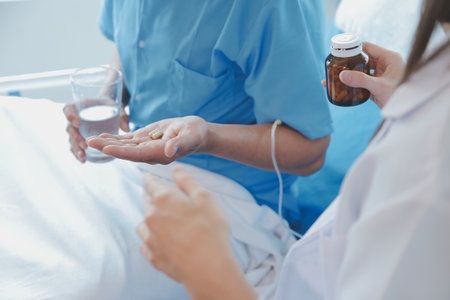 Injured patient showing doctor broken wrist and arm with bandage in hospital office or emergency room. Sprain, stress fracture or repetitive strain injury in hand. Nurse helping customer. First aid.の写真素材