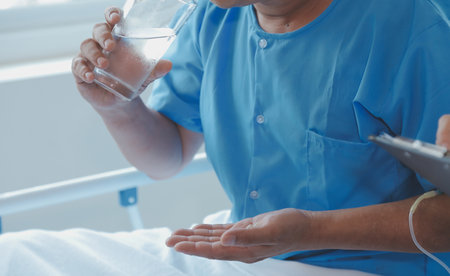 Injured patient showing doctor broken wrist and arm with bandage in hospital office or emergency room. Sprain, stress fracture or repetitive strain injury in hand. Nurse helping customer. First aid.の写真素材