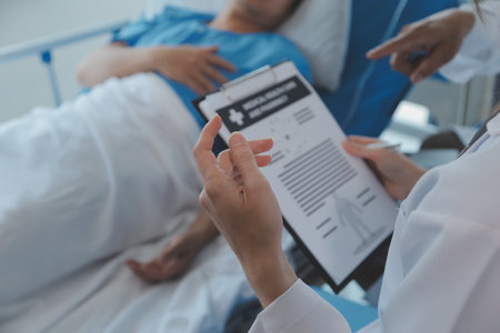 Injured patient showing doctor broken wrist and arm with bandage in hospital office or emergency room. Sprain, stress fracture or repetitive strain injury in hand. Nurse helping customer. First aid.の写真素材