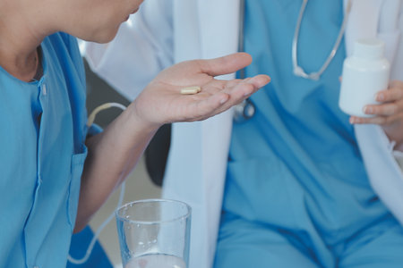 Injured patient showing doctor broken wrist and arm with bandage in hospital office or emergency room. Sprain, stress fracture or repetitive strain injury in hand. Nurse helping customer. First aid.の写真素材