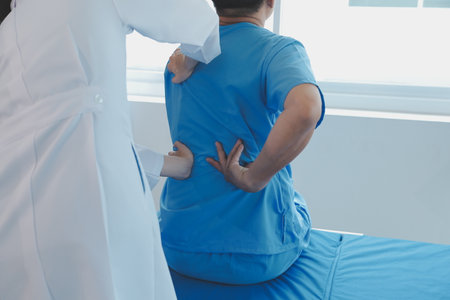 Patient doing some special exercises under supervision in a roomの写真素材