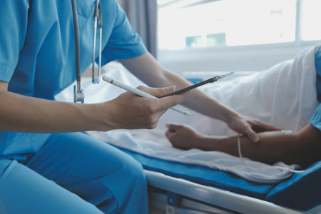 Injured patient showing doctor broken wrist and arm with bandage in hospital office or emergency room. Sprain, stress fracture or repetitive strain injury in hand. Nurse helping customer. First aid.の写真素材