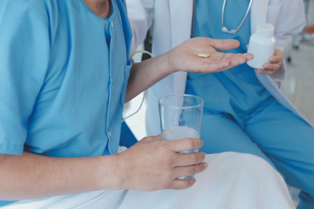 Injured patient showing doctor broken wrist and arm with bandage in hospital office or emergency room. Sprain, stress fracture or repetitive strain injury in hand. Nurse helping customer. First aid.の写真素材