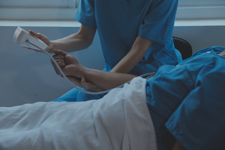 Injured patient showing doctor broken wrist and arm with bandage in hospital office or emergency...