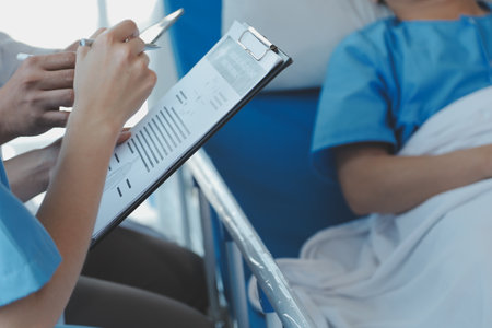 Injured patient showing doctor broken wrist and arm with bandage in hospital office or emergency room. Sprain, stress fracture or repetitive strain injury in hand. Nurse helping customer. First aid.の写真素材