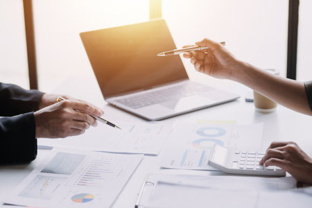 Businesswoman or accountant working Financial investment on calculator, calculate, analyze business and marketing growth on financial document data graph, Accounting, Economic, commercial concept.の写真素材