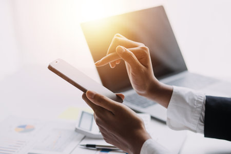 Businesswoman or accountant working Financial investment on calculator, calculate, analyze business and marketing growth on financial document data graph, Accounting, Economic, commercial concept.の写真素材