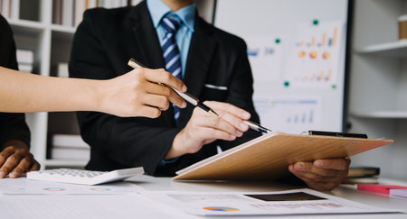 Businesswoman or accountant working Financial investment on calculator, calculate, analyze business and marketing growth on financial document data graph, Accounting, Economic, commercial concept.の写真素材