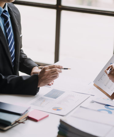 Businesswoman or accountant working Financial investment on calculator, calculate, analyze business and marketing growth on financial document data graph, Accounting, Economic, commercial concept.の写真素材