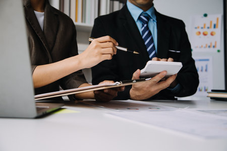Businesswoman or accountant working Financial investment on calculator, calculate, analyze business and marketing growth on financial document data graph, Accounting, Economic, commercial concept.の写真素材