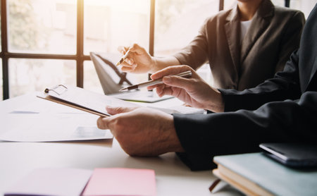 Businesswoman or accountant working Financial investment on calculator, calculate, analyze business and marketing growth on financial document data graph, Accounting, Economic, commercial concept.の写真素材