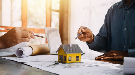 Two business man construction site engineer. Engineering objects on workplace with partners interacting on backgroundの写真素材