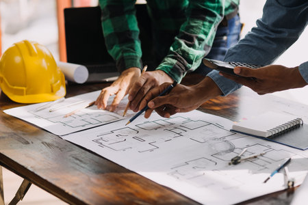 Two business man construction site engineer. Engineering objects on workplace with partners...