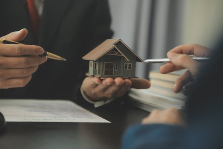 Justice and Law concept. Legal counsel presents to the client a signed contract with gavel and legal law or legal having team meeting at law firm in backgroundの写真素材