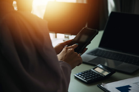 Financial analysts analyze business financial reports on a digital tablet planning investment project during a discussion at a meeting of corporate showing the results of their successful teamwork.の写真素材