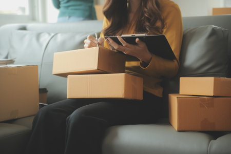 Business woman start up small business entrepreneur SME success .freelance woman working at home with Online Parcel delivery. SME and packaging deliveryconceptの写真素材