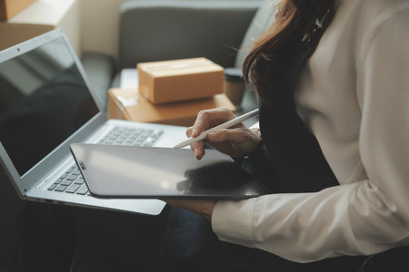 Business woman start up small business entrepreneur SME success .freelance woman working at home with Online Parcel delivery. SME and packaging deliveryconceptの写真素材