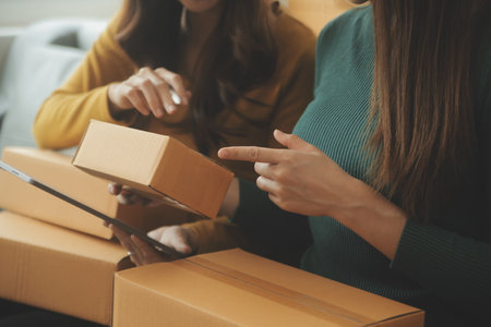 Business woman start up small business entrepreneur SME success .freelance woman working at home with Online Parcel delivery. SME and packaging deliveryconceptの写真素材