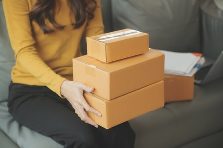 Business woman start up small business entrepreneur SME success .freelance woman working at home with Online Parcel delivery. SME and packaging deliveryconceptの写真素材