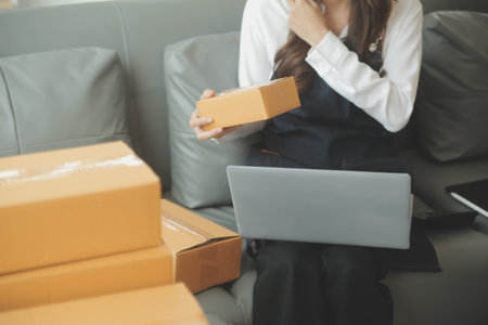Business woman start up small business entrepreneur SME success .freelance woman working at home with Online Parcel delivery. SME and packaging deliveryconceptの写真素材