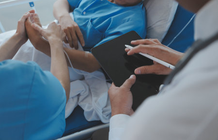Injured patient showing doctor broken wrist and arm with bandage in hospital office or emergency...