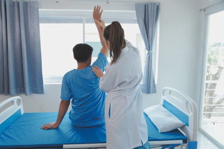 Patient doing some special exercises under supervision in a roomの写真素材