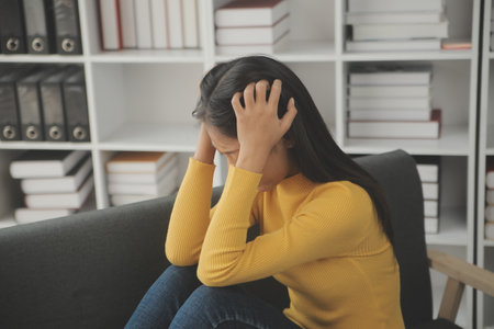 Portrait of tired young business Asian woman work with documents tax laptop computer in office. Sad, unhappy, Worried, Depression, or employee life stress conceptの写真素材