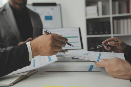Financial analysts analyze business financial reports on a digital tablet planning investment...