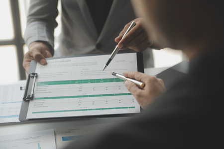 Financial analysts analyze business financial reports on a digital tablet planning investment...