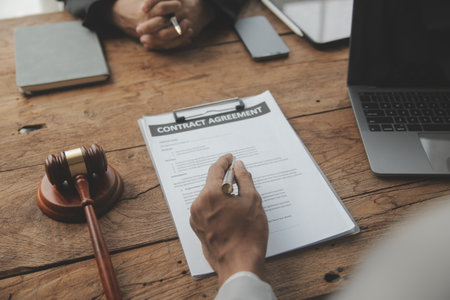 Judge gavel with Justice lawyers having team meeting at law firm in background. Concepts of law.の写真素材